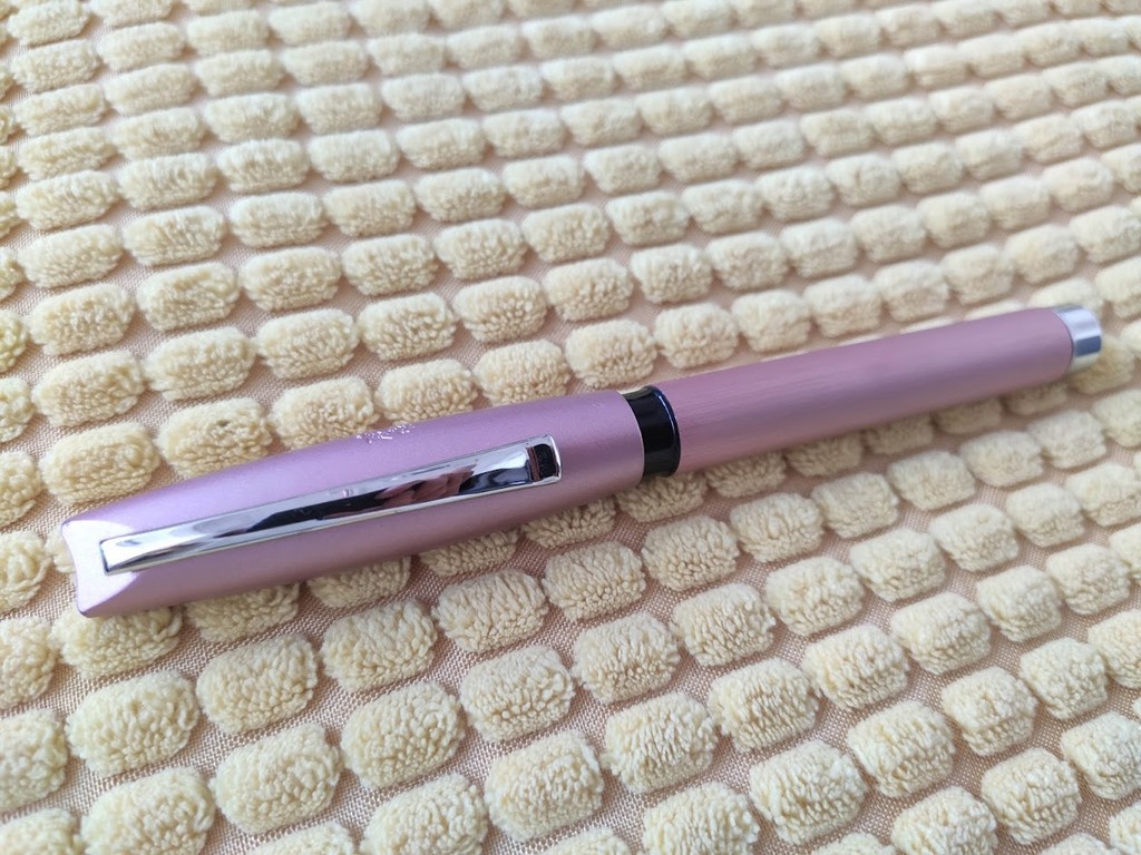 Faber-Castell Essentio Fountain Pen in Rose Gold Aluminium on a Beige Textured Fabric Background