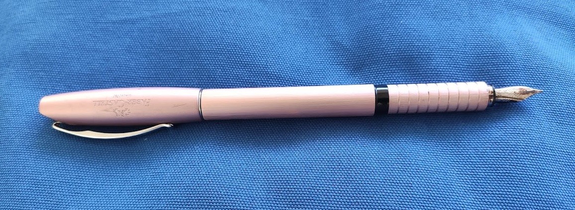 Faber-Castell Essentio in Rose Gold Aluminium on a Blue Fabric Background